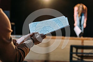 Theater director with scenario applauding to