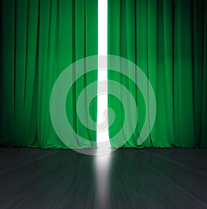 Theater green curtain slightly open with bright light behind and wood stage or scene