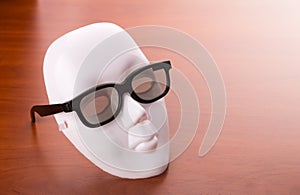 Theater mask in glasses on the table
