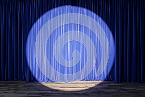 Theater stage with blue curtains highlighted by spotlight, anticipation of night\'s event.