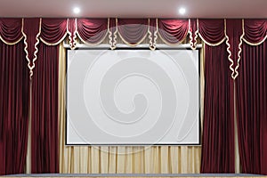 A theater stage with a red curtain.