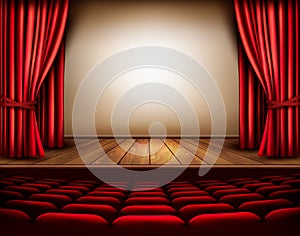 A theater stage with a red curtain, seats.