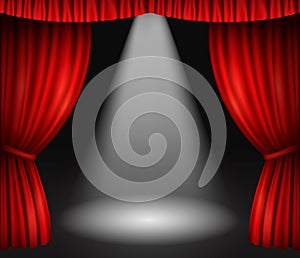 Theater stage with red curtains and spotlight