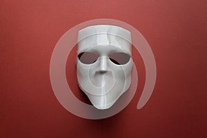 Theatre concept with the white masks on trendy terracotta background. Anonimous, Incognito, Conspiracy concept. Place for text.