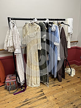 Theatre costumes hanging on a rail backstage.