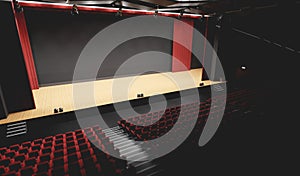 Theatre with empty stage in spotlight. Red theater curtain and seats