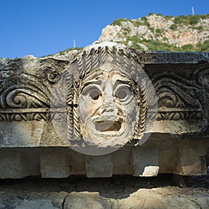 Theatrical mask stone carving of ancient town of Myra in Lycia region, ancient city of Myra in Demre, Turkey