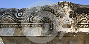 Theatrical mask stone carving of ancient town of Myra in Lycia region, Antique, Ruins of ancient city of Myra in Demre, Tu photo