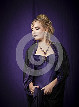 Theatrical portrait of blonde woman in purple Byzantine period dress