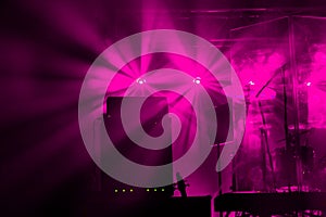 Theatrical stage rock concert. Beams of searchlights, light, abstract background of concert. Stage lights during light and music