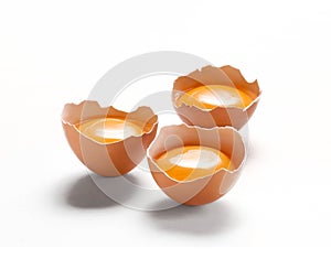 Thee opened eggshell  and egg yolk isolated on white