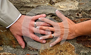 She and he and their hands with wedding rings