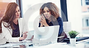 Their tool of choice for team tasks. two businesswomen using a digital tablet together during a collaboration at work.