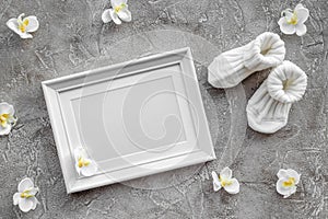 Theme for baby shower with shoes and white frame gray background top view space for text