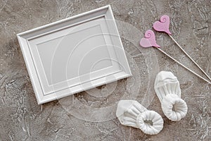 Theme for baby shower with shoes and white frame gray background top view space for text