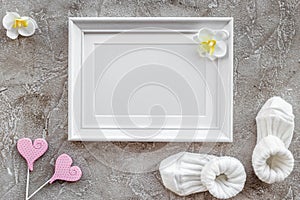 Theme for baby shower with shoes and white frame gray background top view space for text