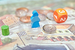 Themed Board games. colorful play figures with dice on Board. vertical view of the Board game close-up