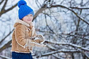 Theme Christmas holidays New Year. Winter snow and child game. Happy winter time for kid. Joyful little boy child Having