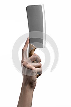 The theme of the kitchen: Chef hand holding a large kitchen knife for cutting meat on a white background isolated