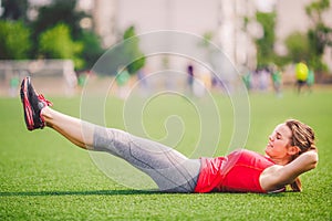 Theme sport and health. Young beautiful Caucasian woman doing warm-up, warming up muscles, abdominal muscles workout, losing belly