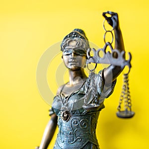 Themis Greek goddess of justice on yellow background