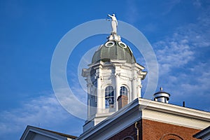 Themis with scales in her hand on the dome of a building in New England