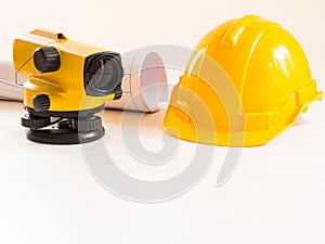 Theodolite and construction helmet, rolls and plans. on white background. Construction industry concept.