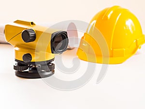 Theodolite and construction helmet, rolls and plans. on white background. Construction industry concept.