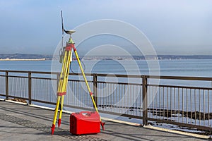 Theodolite measuring instrument. Modern geodetic device on the quay