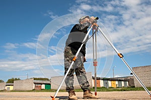 Theodolite on a tripod with construction worker