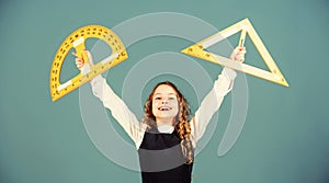 Theorems and axioms. Smart and clever concept. Girl with big ruler. School student study geometry. Kid school uniform photo