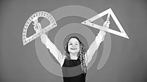 Theorems and axioms. Smart and clever concept. Girl with big ruler. School student study geometry. Kid school uniform photo