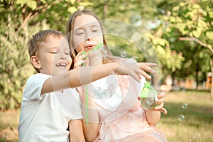 Ther and sister blowing soap bubbles