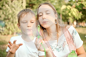Ther and sister blowing soap bubbles