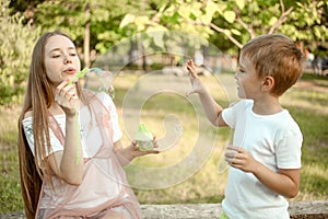 Ther and sister blowing soap bubbles