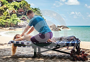 Therapeutic massage on the shore of the tropical sea. Travel, he