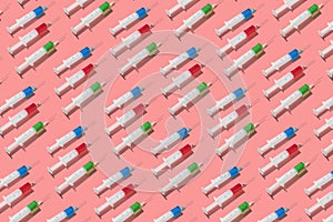 Therapeutic pattern of plastic syrenges with colorful vaccines.