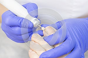 Therapeutic pedicure. Master podologist does hardware pedicure. visit to the podiatry. Foot treatment in the spa. photo