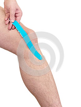 Therapeutic treatment of knee with kinesio tex tape.
