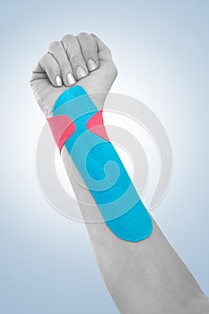 Therapeutic treatment of wrist with tex tape.