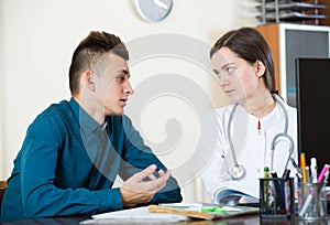 Therapeutist receiving teenage patient in clinic