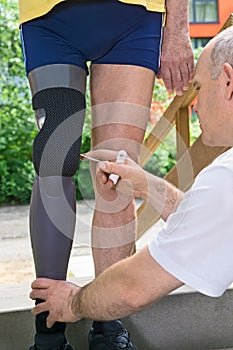Therapist adjusting prosthetic leg