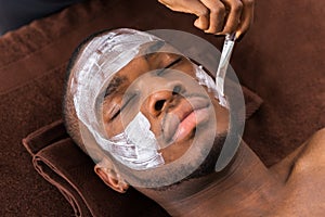 Therapist Applying Face Mask To Man photo