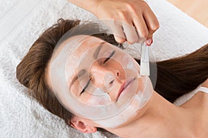 Therapist Applying Face Mask To Woman