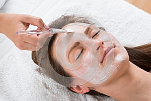 Therapist Applying Face Mask To Woman