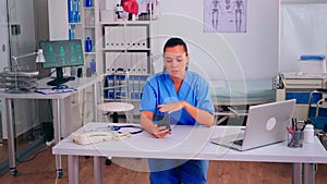 Therapist assistant holding smartphone talking to patient