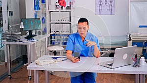 Therapist assistant holding smartphone talking to patient