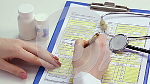 Therapist completing health insurance claim form, payment for medical benefits