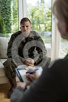 Therapist diagnosing soldier