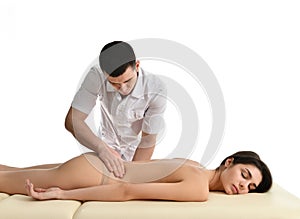Therapist doctor examining his patient stomach or making abdomen massage isolated on white